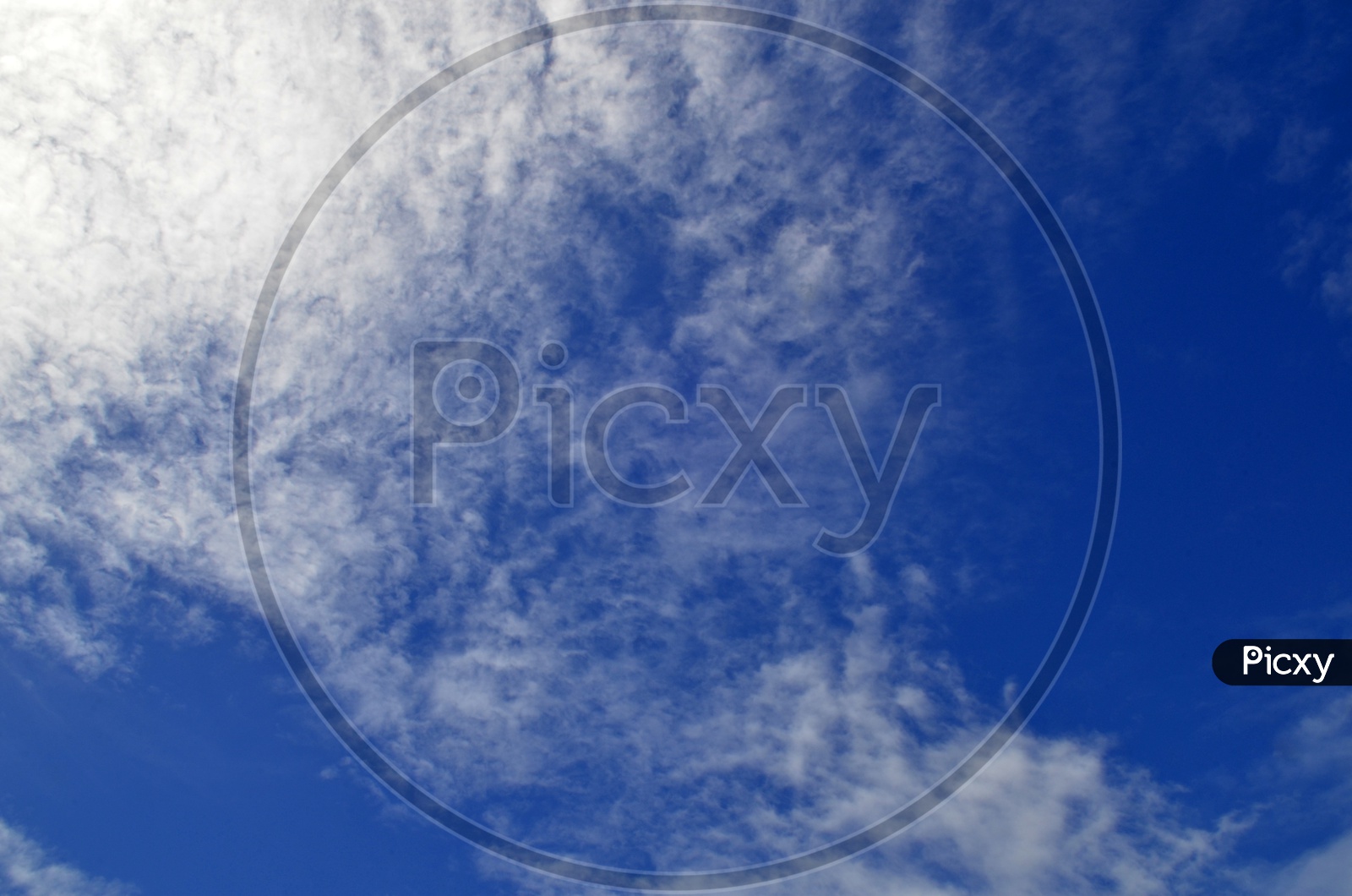 Abstract of Blue Sky With Cotton Clouds