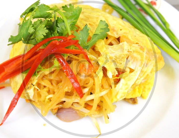 Stir fry noodles with shrimp garnished with coriander leaves
