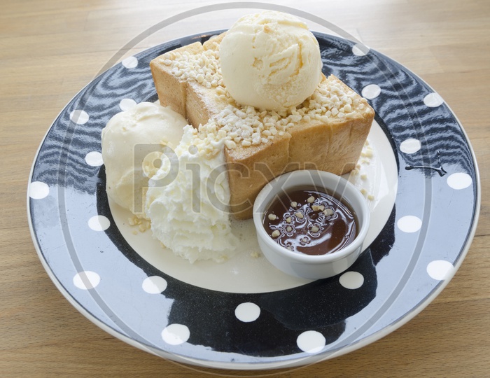 Honey Toast bread topped with honey and ice cream in a Plate