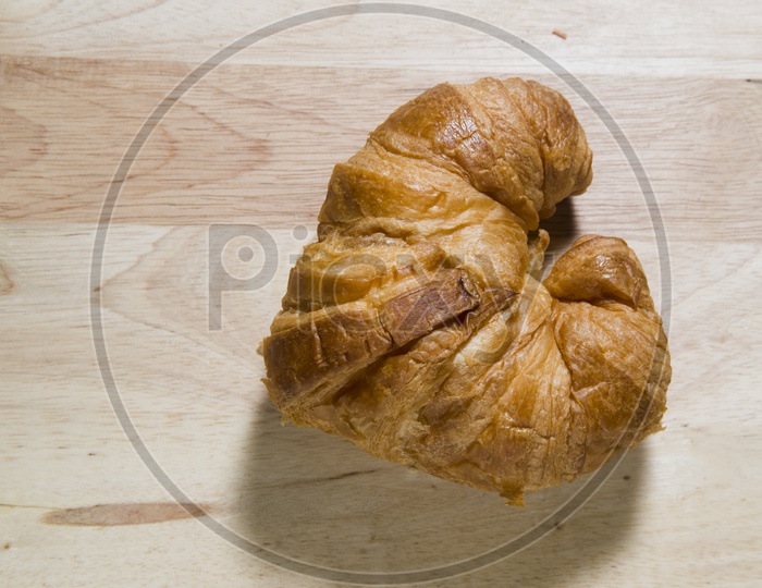 Fresh and tasty Croissant on wooden background