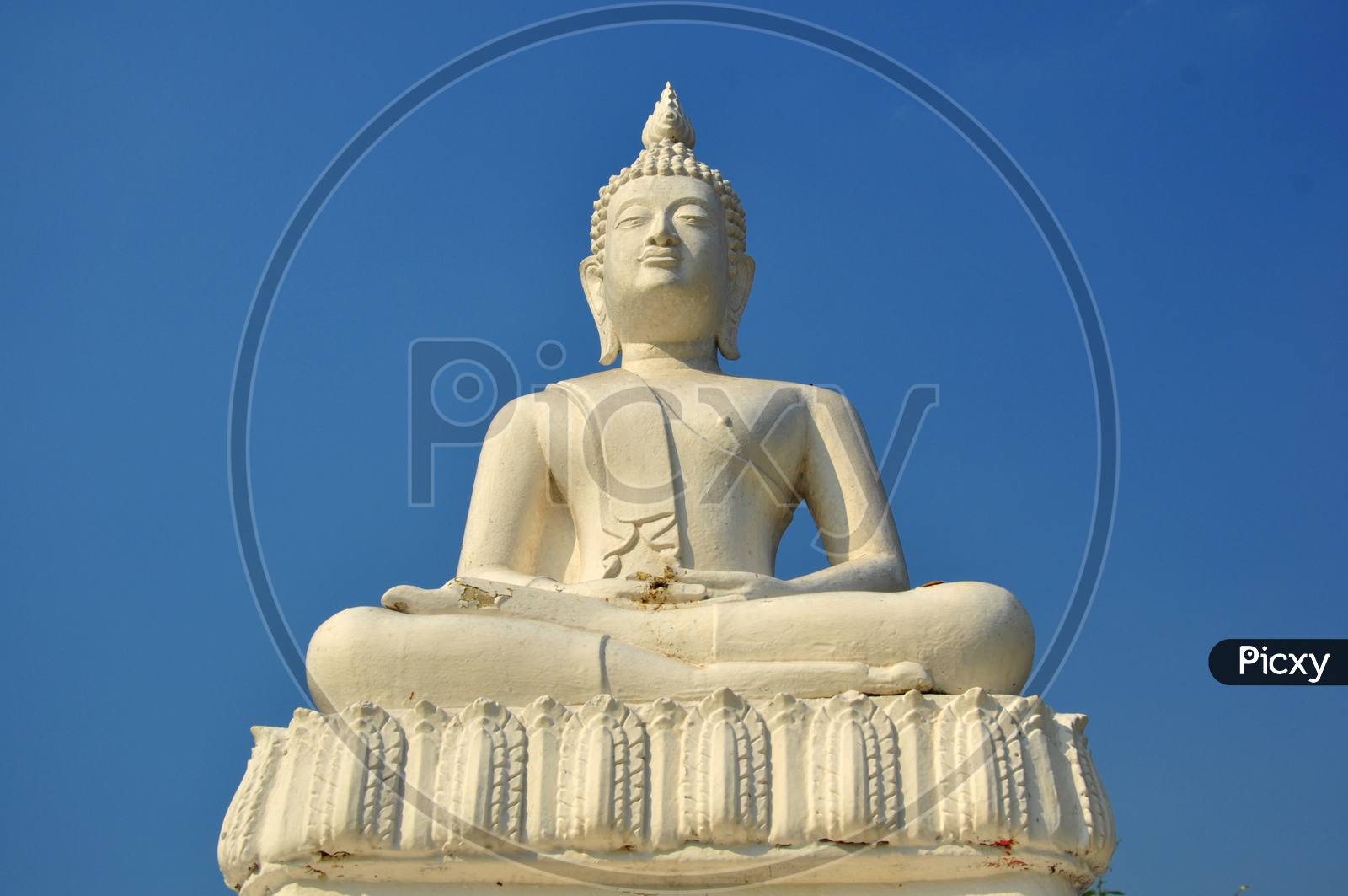 A White Buddha statue with blue sky in Thailand