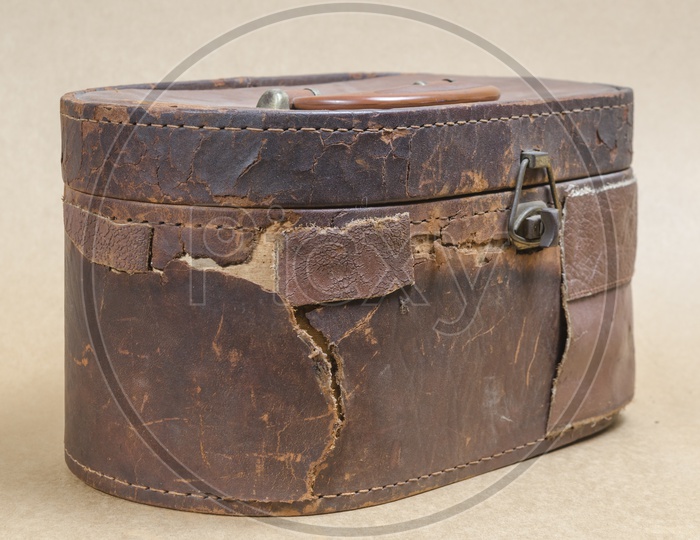 Old brown leather bag in brown vintage background
