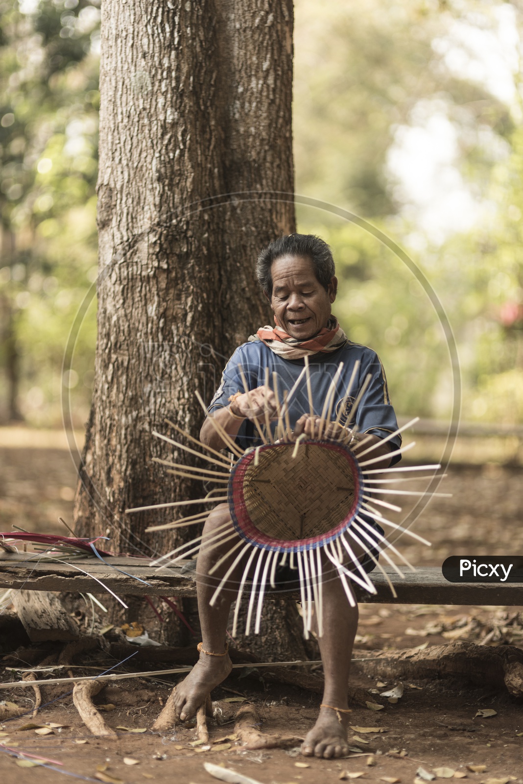 Alak tribe man Crafting of Thatched Specimens in village near plateau Bolaven, Laos