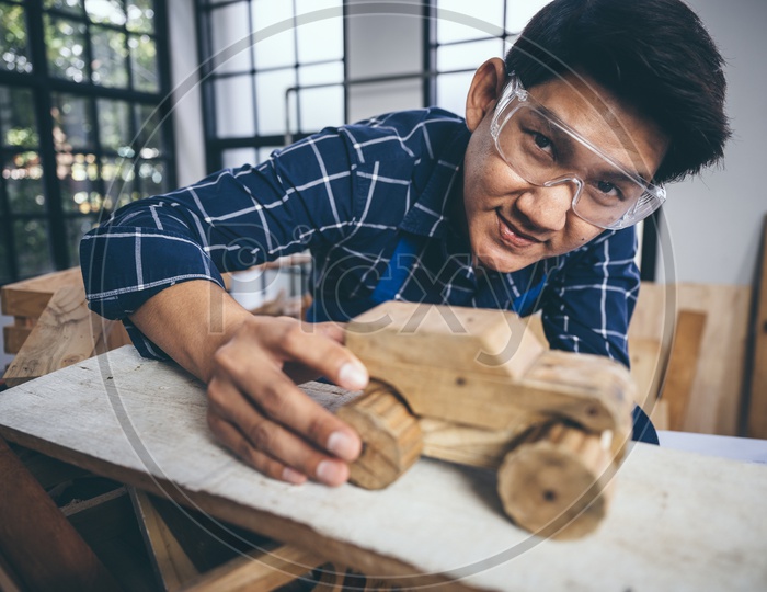 A Thai Carpenter exhibiting his wood craft