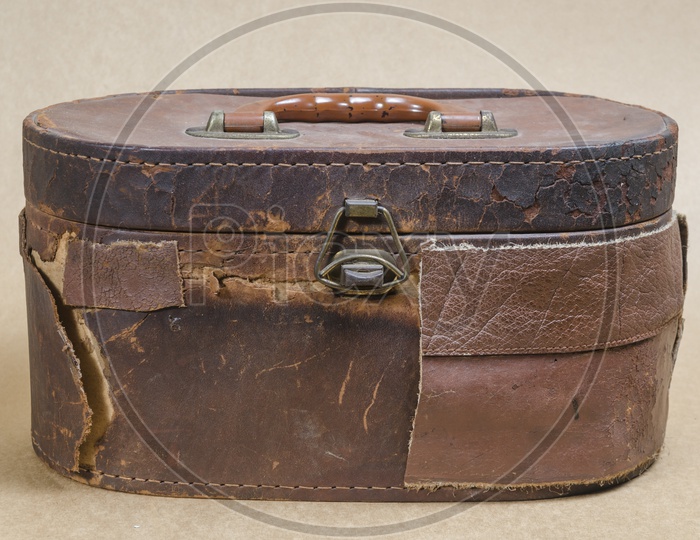 Old brown leather bag in brown vintage background