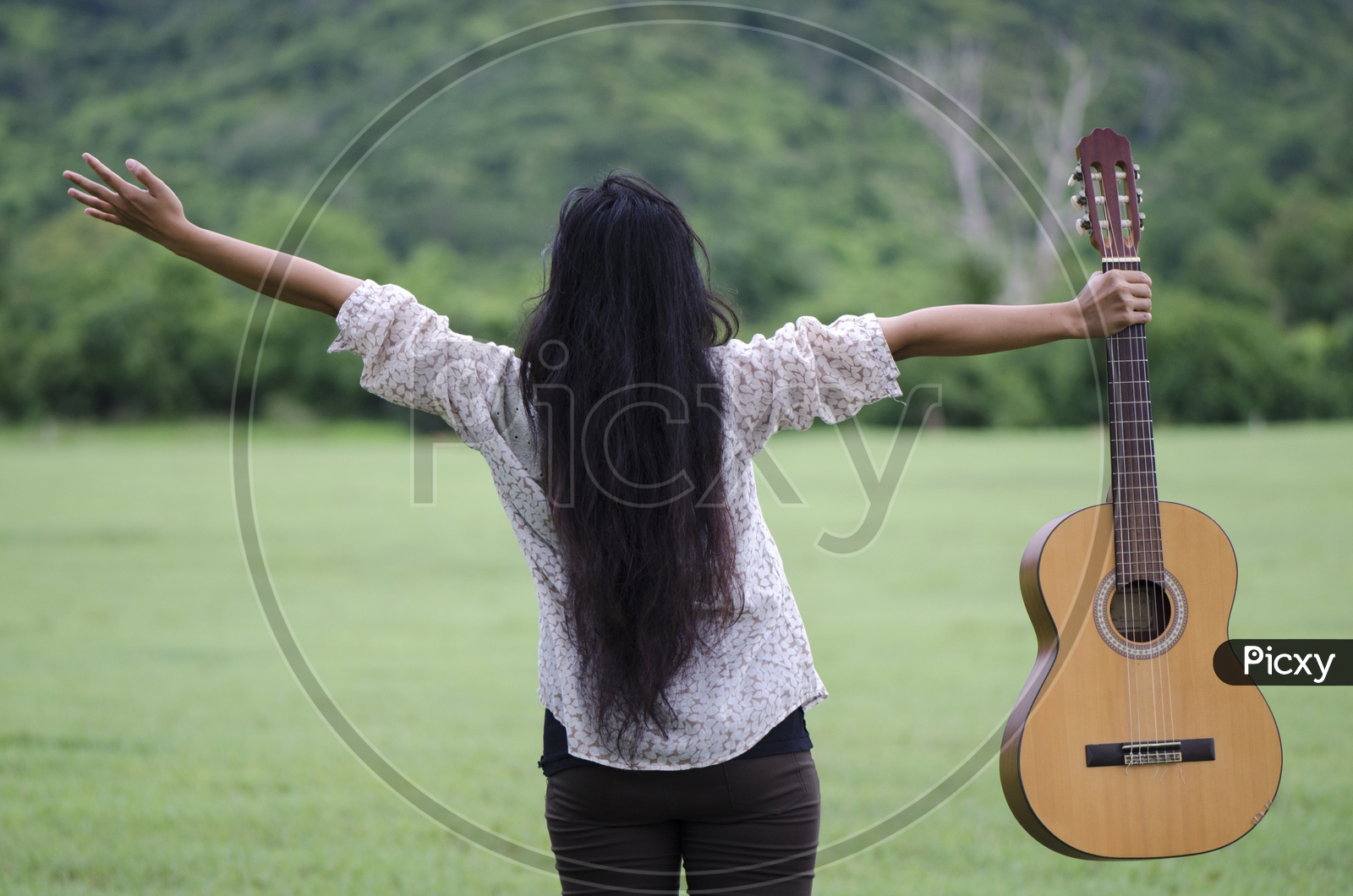 Woman with guitar Enjoying In Nature