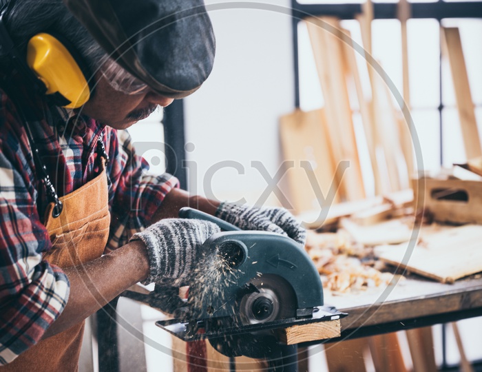 A Thai carpenter using a circular saw tool