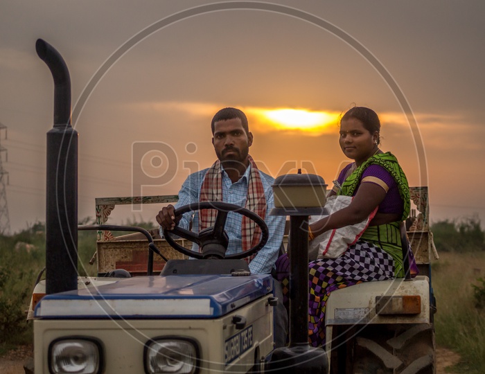 A farmer's family heading home on tractor