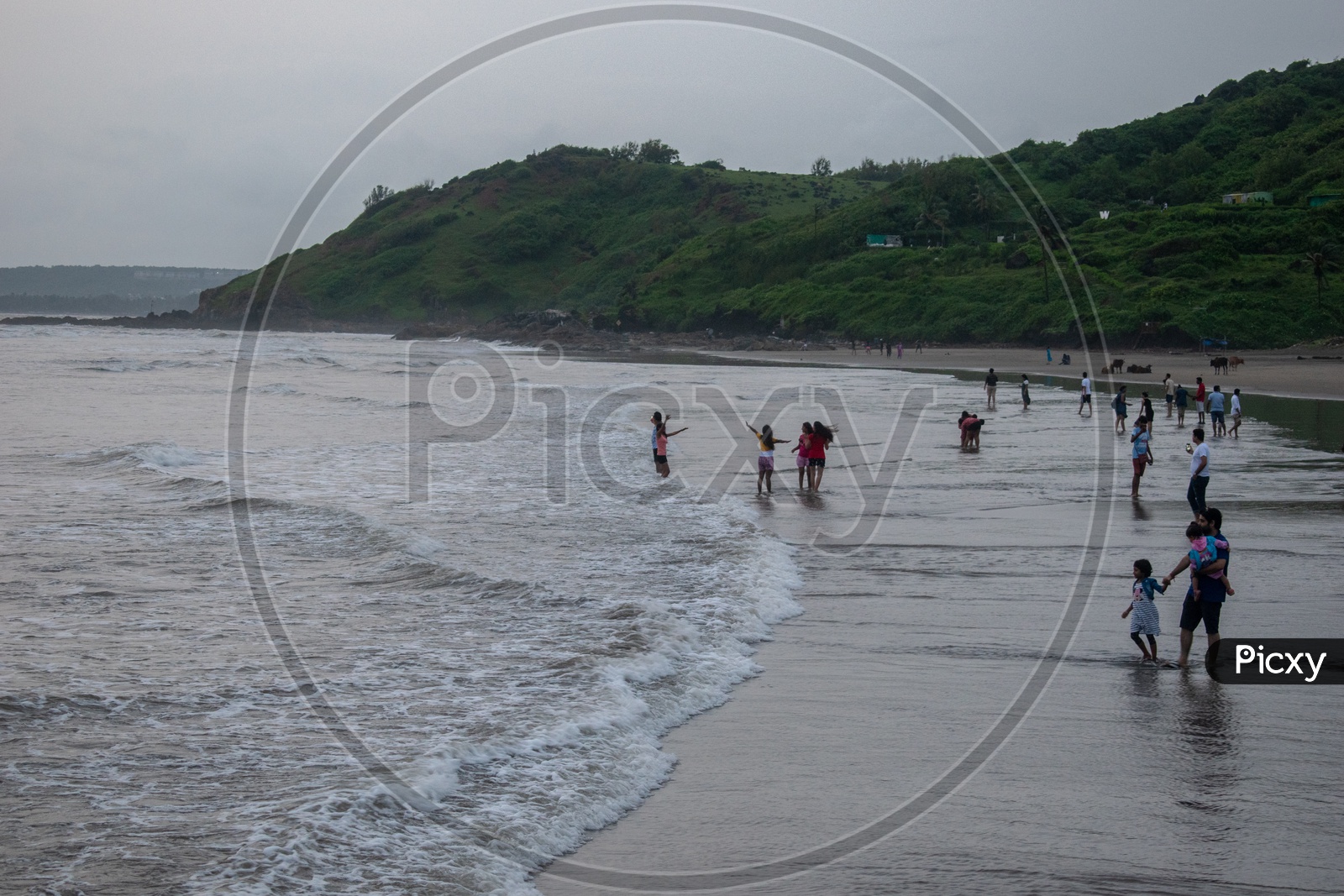 People enjoying at Sinquerium Beach Goa, Candolim, Goa, India