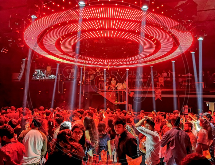 Crowd of People Having Fun and Enjoying Music By Dancing in  a Club Party