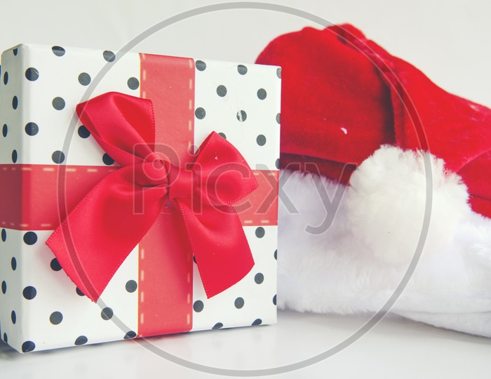 Santa Claus hat And Christmas Gift Over an isolated White Background