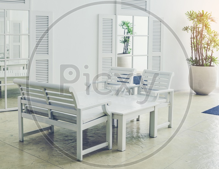 An organized space with white chairs and tables