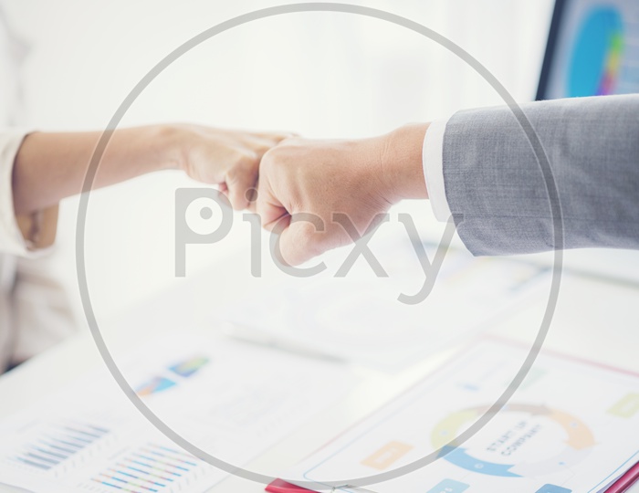 Two businessmen doing fist bump