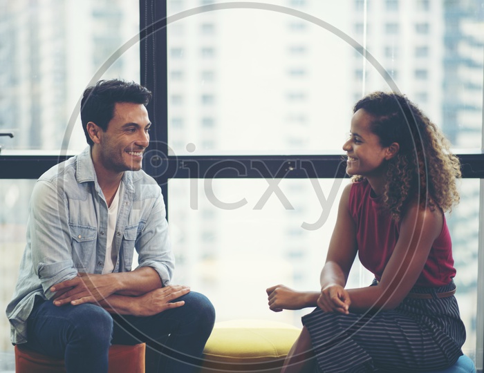 Young Man And Woman on a Date Talking To each Other With Smile