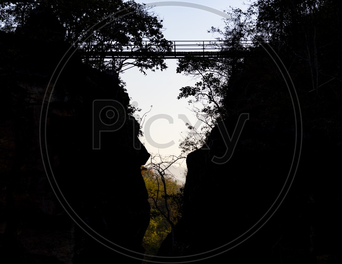 Wooden Bridge Between Mountain  Silhouette