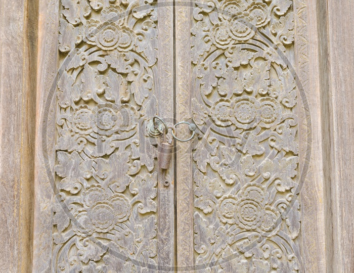 Ancient door with carvings of Taman Ayun Temple in Bali.
