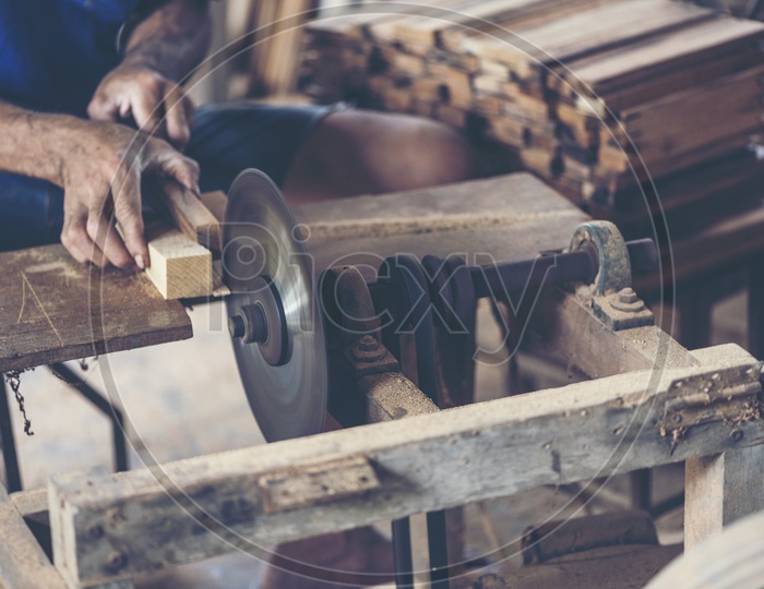 Background image of woodworking workshop: carpenters work table with different tools and wood cutting stand, vintage filter image