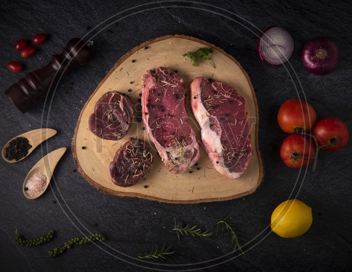 Fresh Raw Red Beef  Steak on Wooden Cutting Board