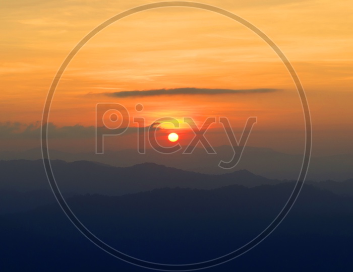 Sunset Over Mountain Landscapes With Golden  Hour Sky in Background