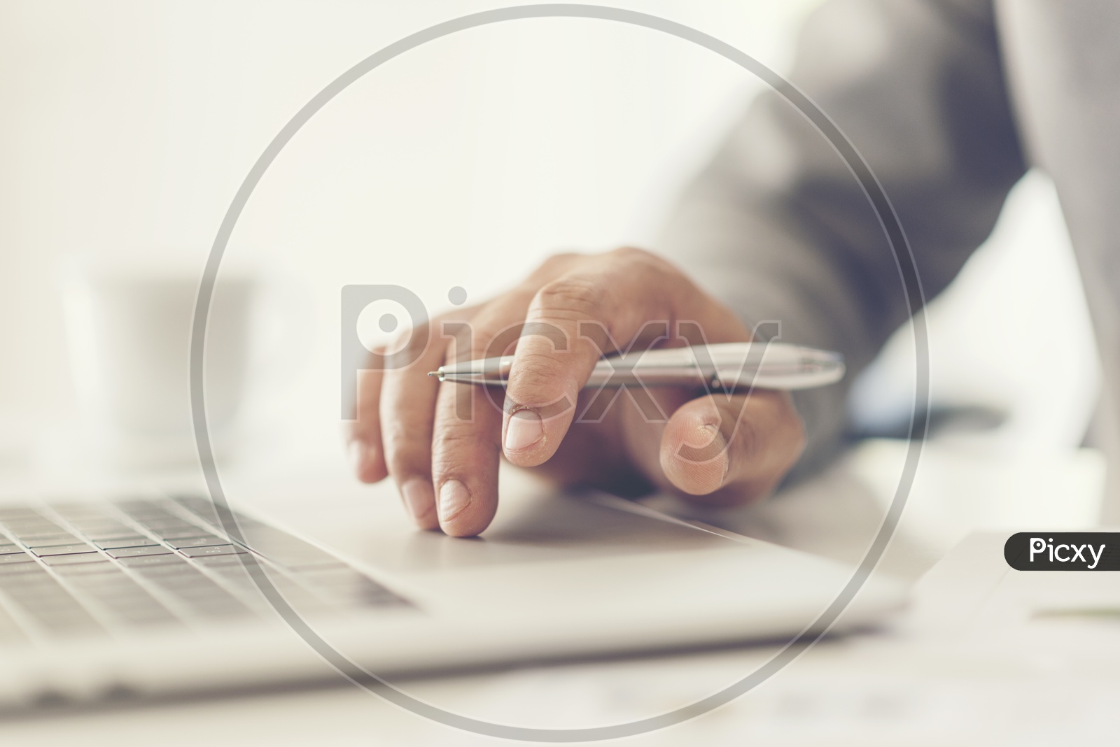 Close-up of male hands using laptop at office,