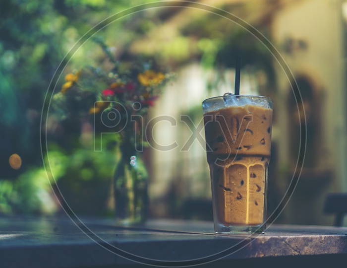 ice coffee glass on wooden table on a Cafe Table