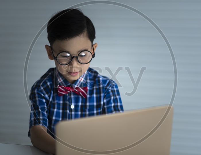 Boy studying with laptop, education concept