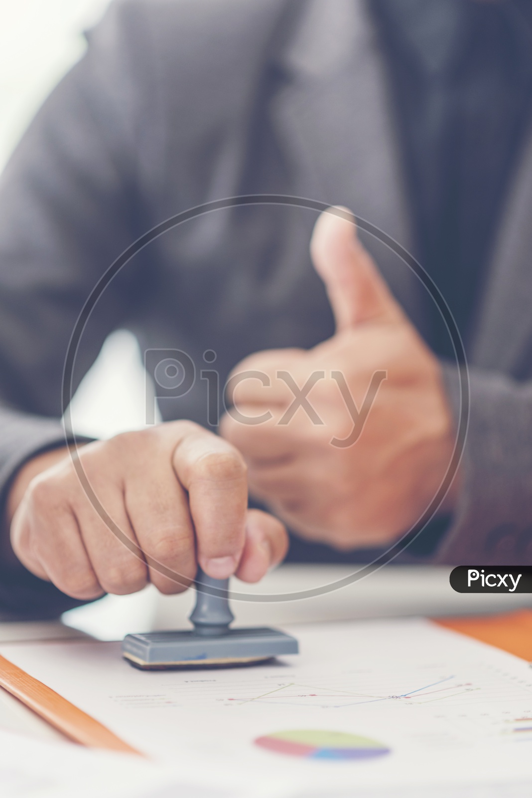 A businessman stamping the documents