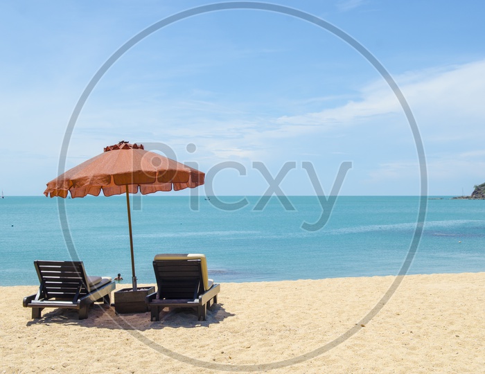 An empty beach benches facing the sea in Thailand