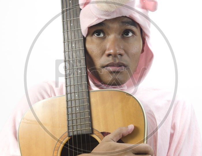 A Musician posing with his guitar in Thailand