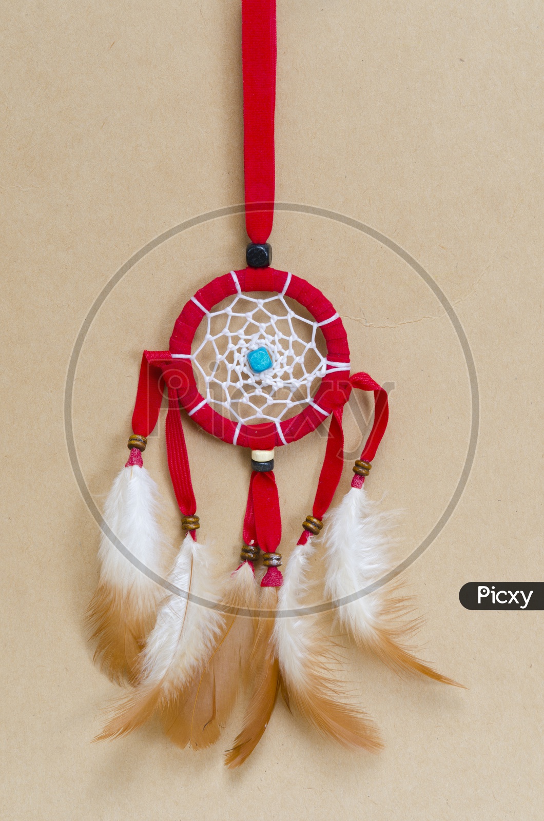 A Red dream-catcher on brown vintage background