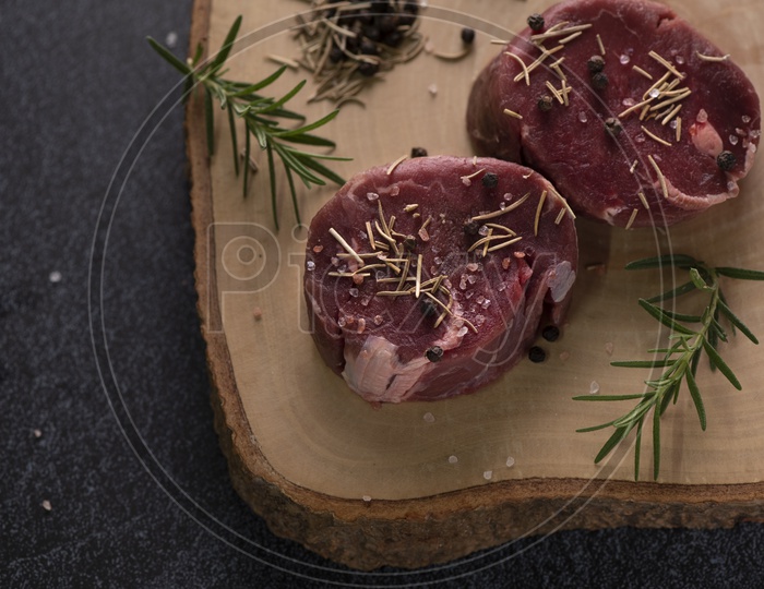 Fresh Raw Red Beef  Steak on Wooden Cutting Board
