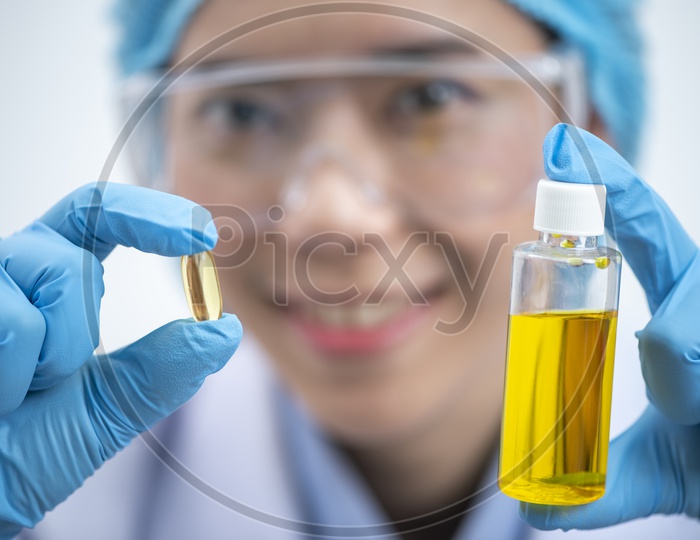 Vitamins.Close Up Of Girl holding Pill With Cod Liver Oil Omega-3. Nutrition. Healthy Nutritional Supplements. Sport, Diet Concept. Vitamin D, E, A Fish Oil Capsules Vitamin And Dietary Supplements