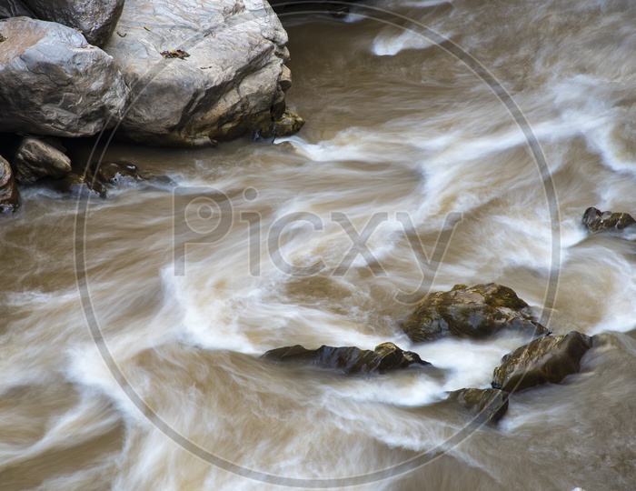 River Flowing With Smooth  Stream  over Rocks As  a Channel