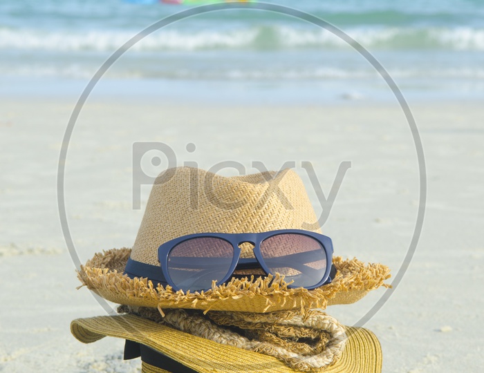 Summer beach bag with straw hat,towel,sunglasses and flip flops