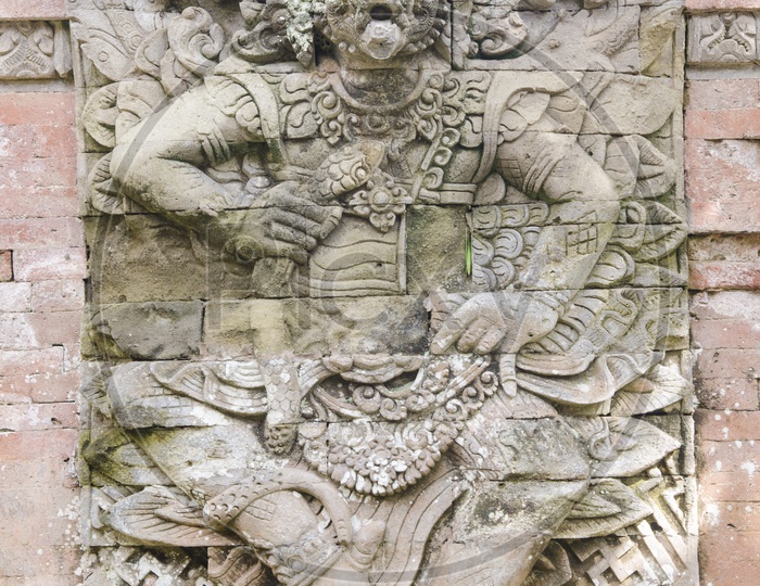 A Balinese Goddess Stone carving on the wall of Taman Ayun Temple in Bali.