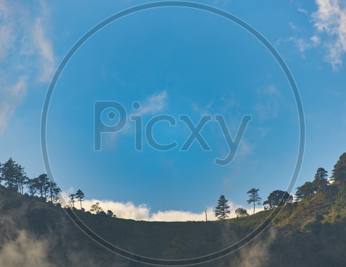 A Landscape of foggy mountains with blue sky in Thailand