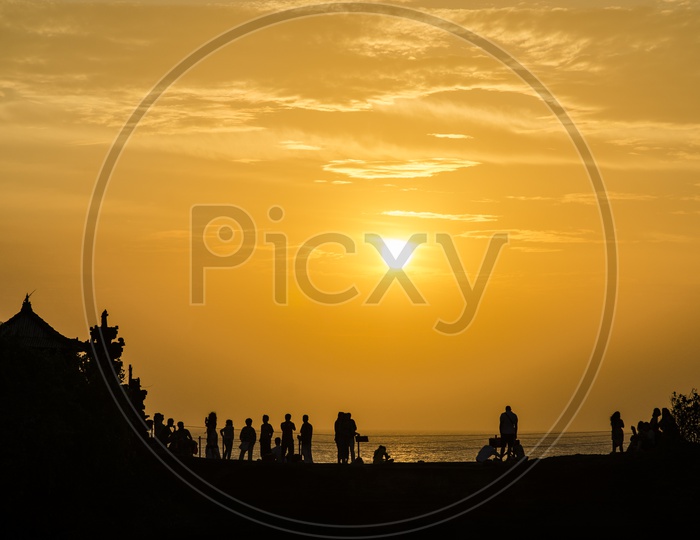 Tourists during sunset at Pura Batu Bolong - Tanah Lot, Bali , Indonesia