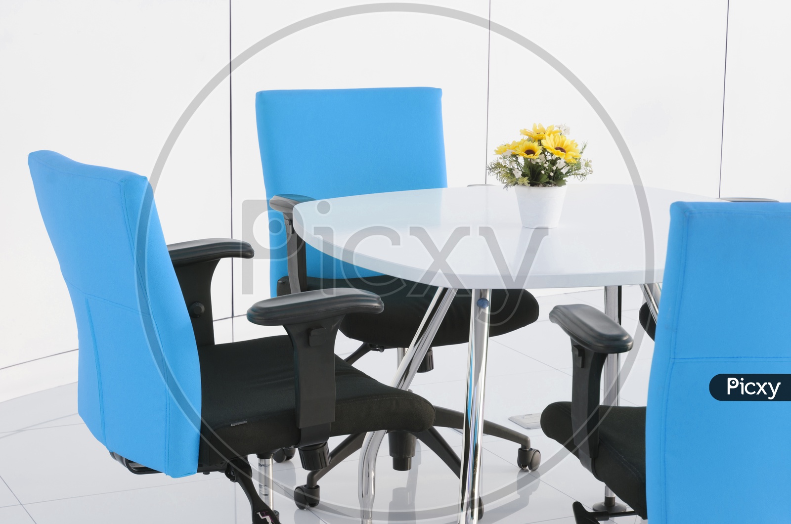 An office table with blue chairs