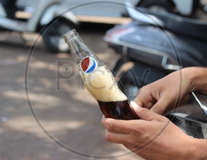 Pepsi cool drink Glass Bottle in Indian man hand