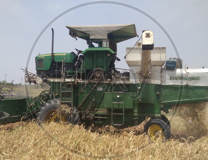 A tractor or harvester in Agriculture Field