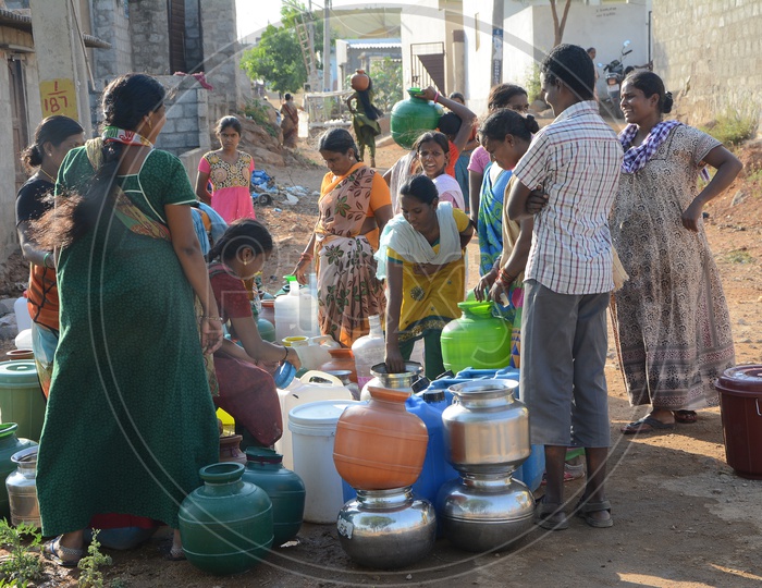 Woman In Queue Lines At Drinking Water Pipeline Taps For Filling Water Vessels in Water Crisis Areas Of Hyderabad