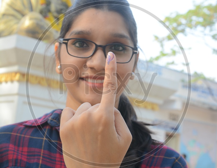 Young Woman  Voter Showing inked Finger After Casting Her Vote in General Elections