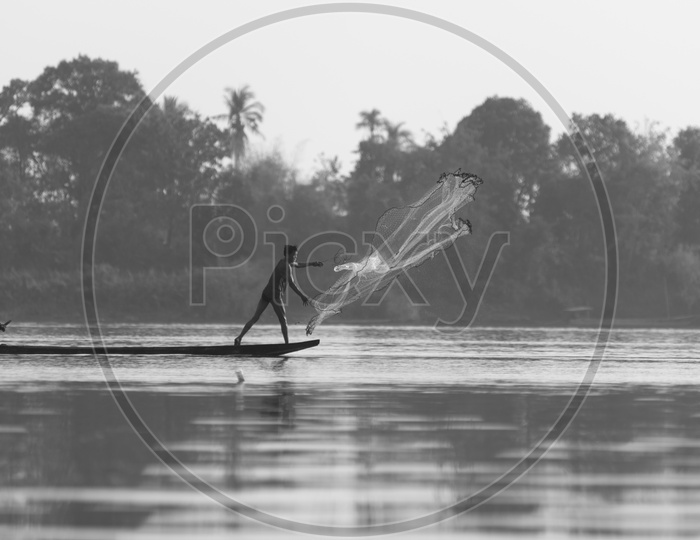 A Fisherman throwing the cast net in Thailand
