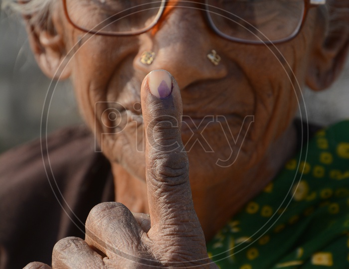 Old woman  Voter Showing inked Finger After Casting Her Vote in General Elections