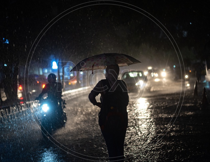 Woman Pedestrian Walking on Flooded Road In Heavy Rain With Umbrella
