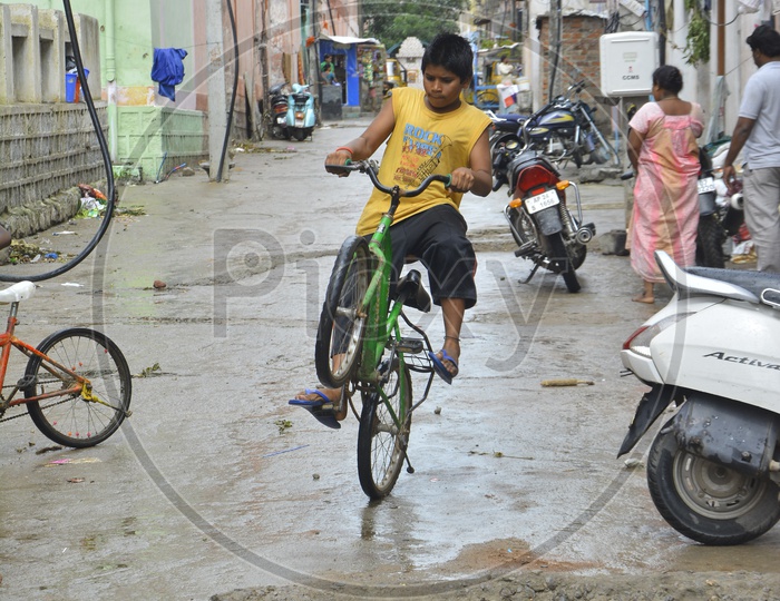 Indian Children Riding Bicycles on Streets