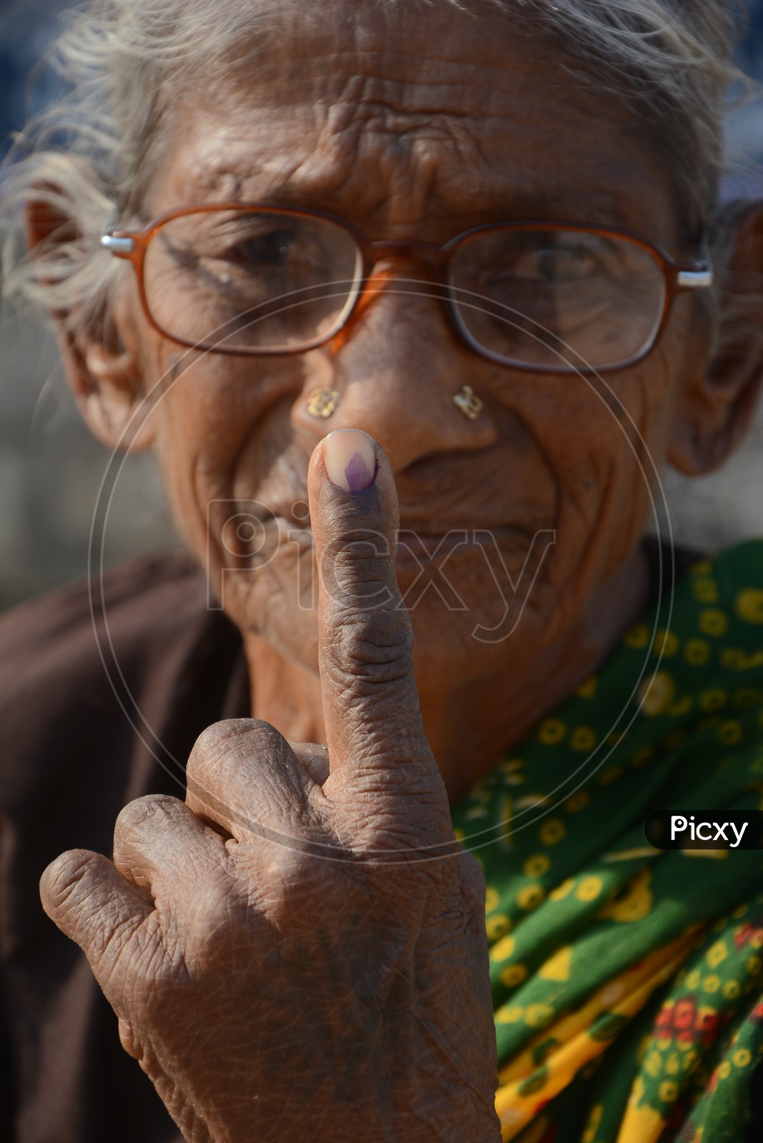 Old woman  Voter Showing inked Finger After Casting Her Vote in General Elections
