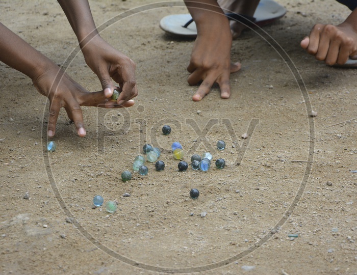 Indian children Playing Marble Striking Game On Rural Villages