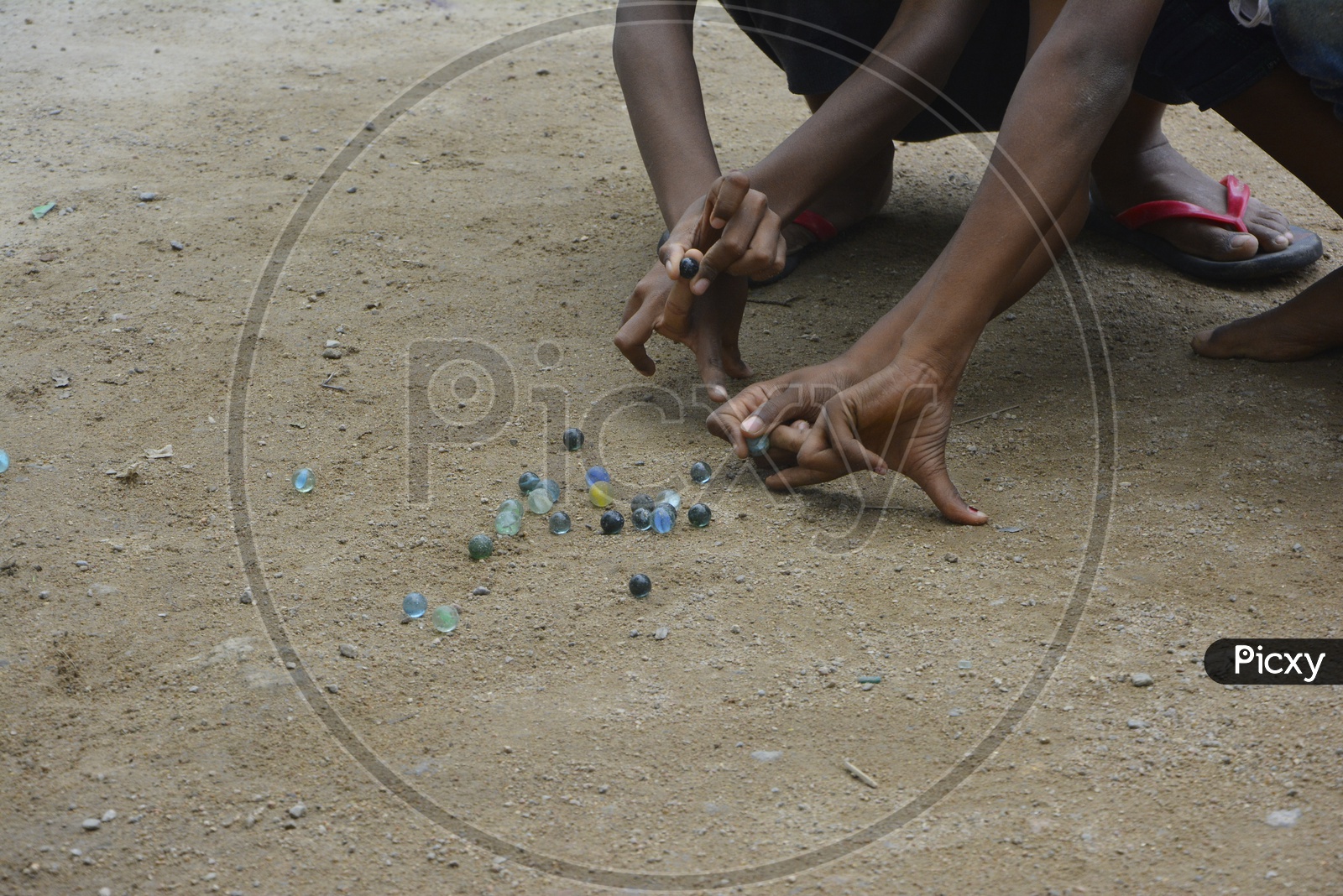 Indian children Playing Marble Striking Game On Rural Villages