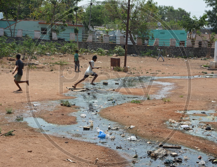 drainage or Sewage Water Overflow At a Play ground In Which Children Playing Cricket